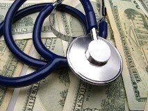 medical stethoscope on background dollar denominations, close up
