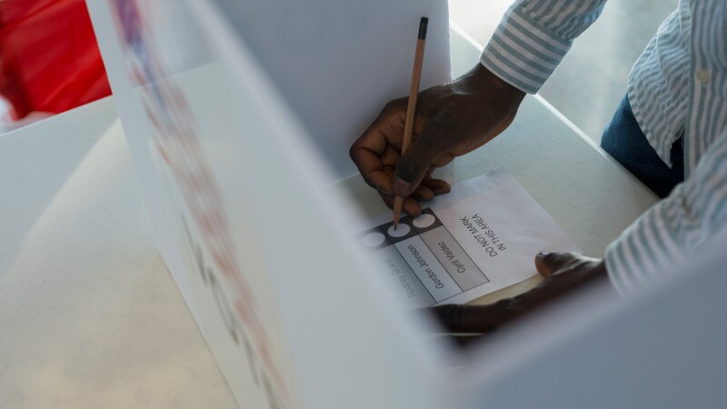 Voter in voting booth