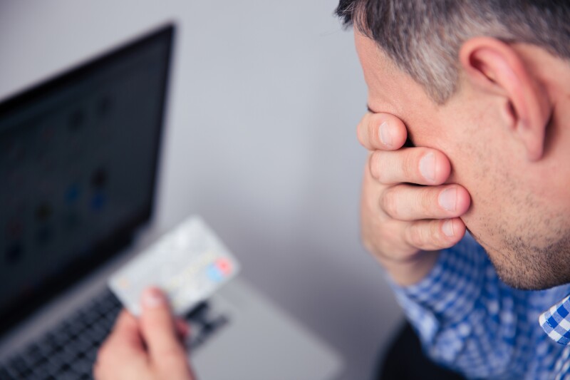 Upset man holding credit card
