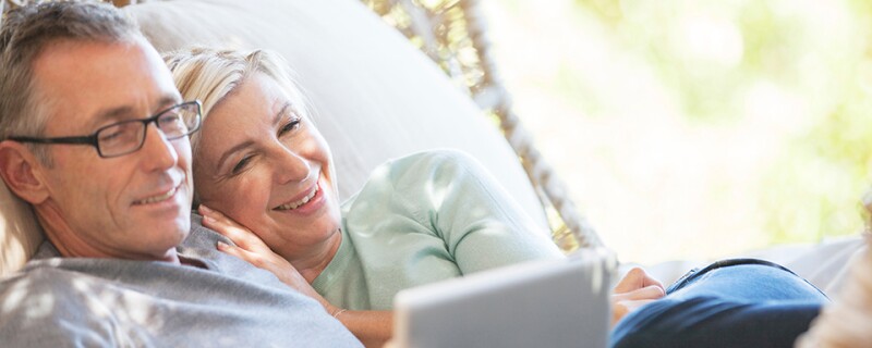 Mature couple using digital tablet outdoors