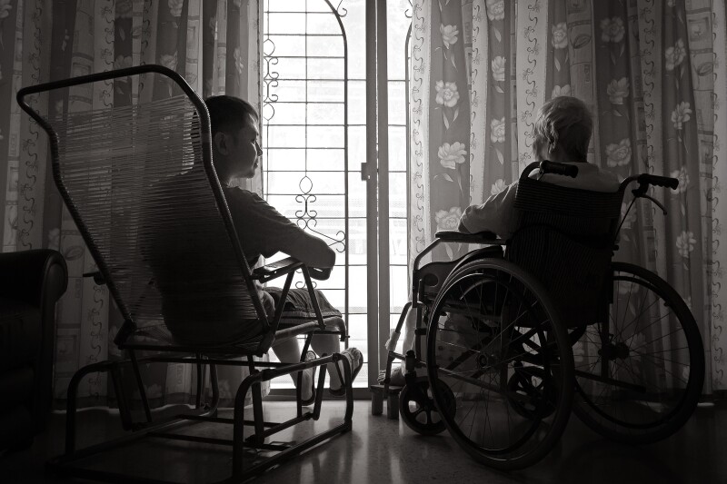 Rear View Of Men Sitting By Window