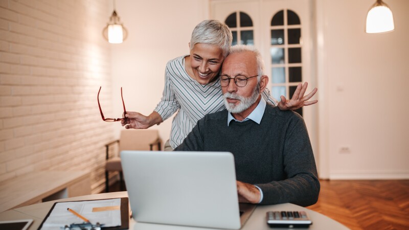An older couple using a computer