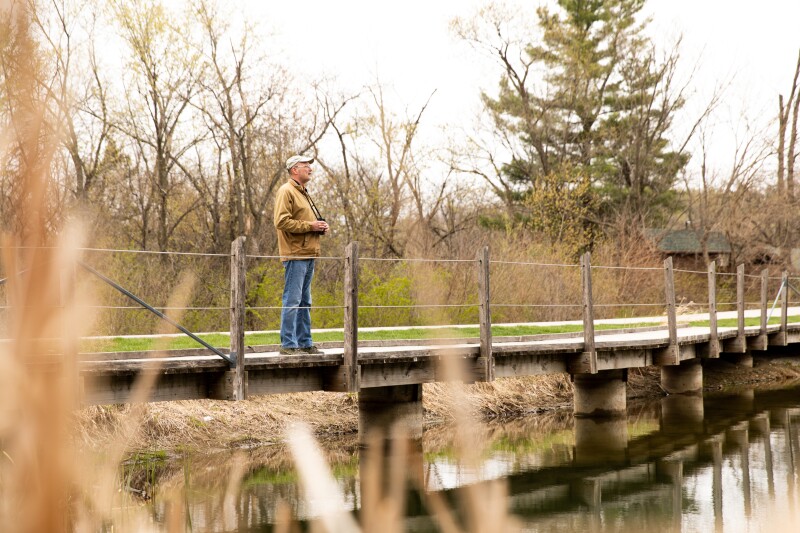 Dennis overlooks naturescape from bridge