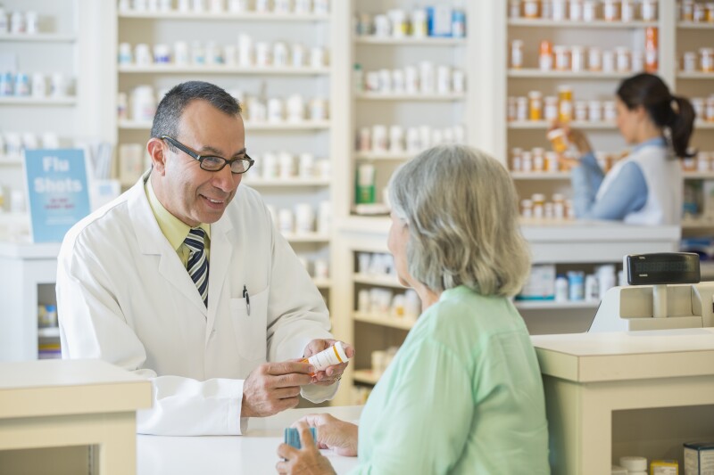 Pharmacist talking to customer