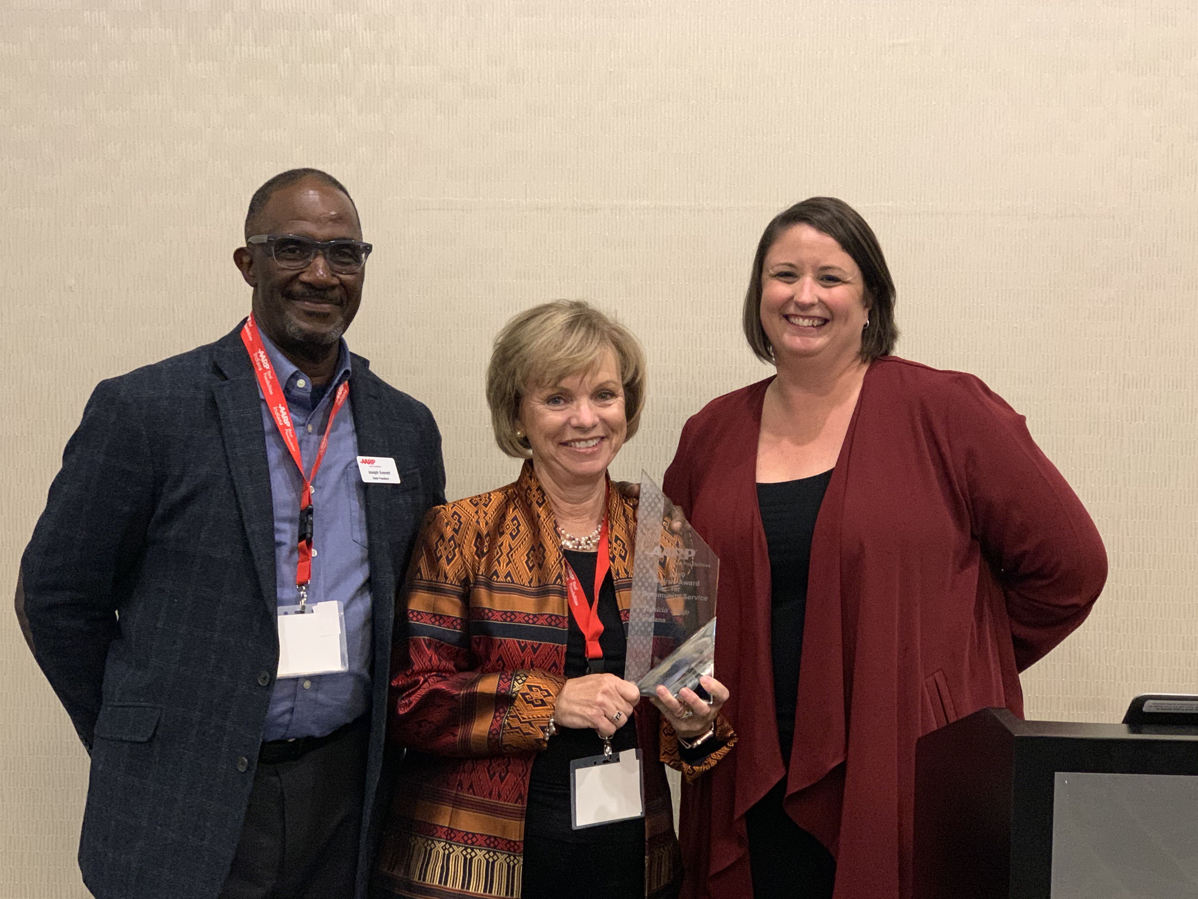 Tish Biggs received the Andrus Award and poses with AARP Indiana State President Joe Everett and State Director Sarah Waddle.