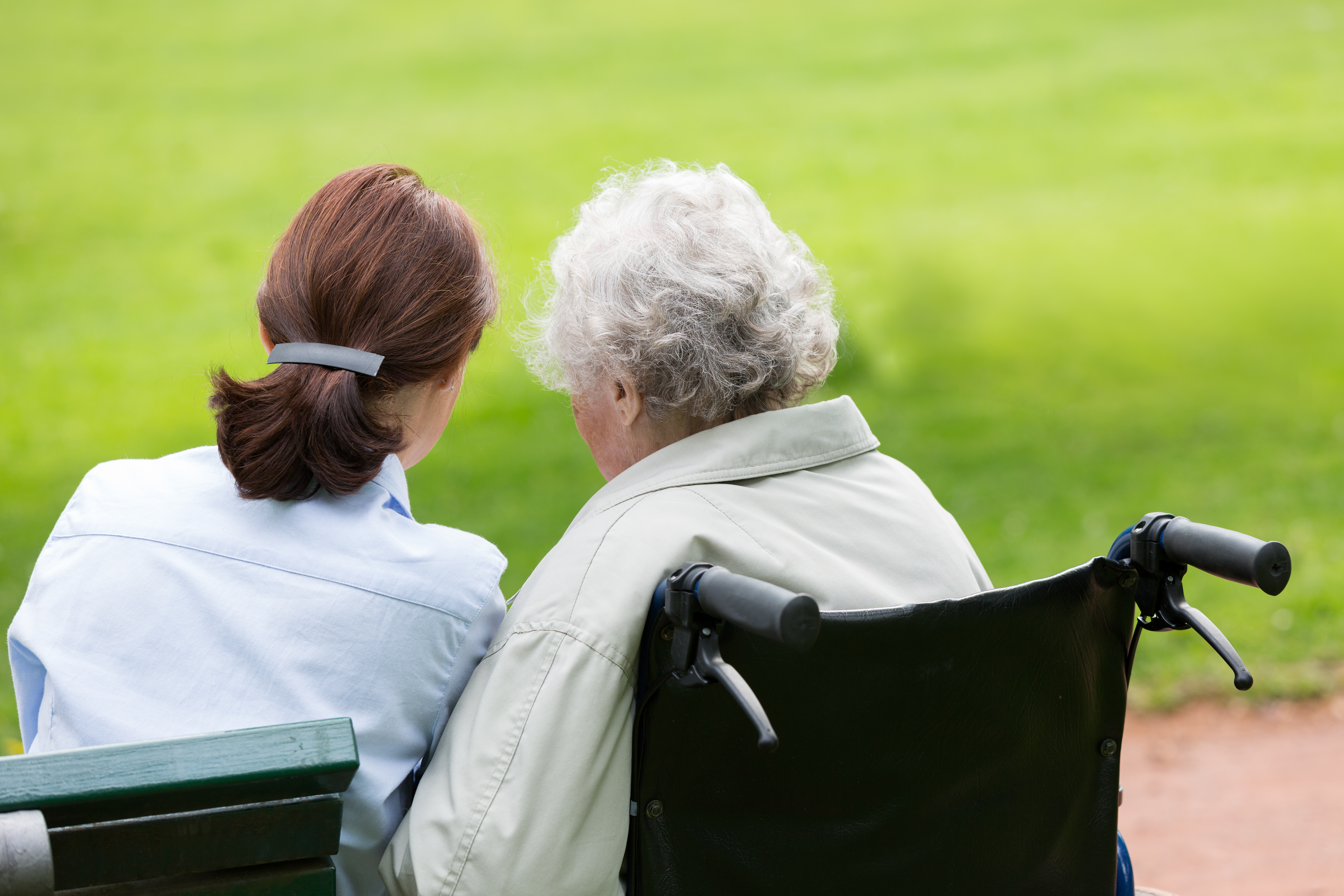 Senior woman with caregiver in the park