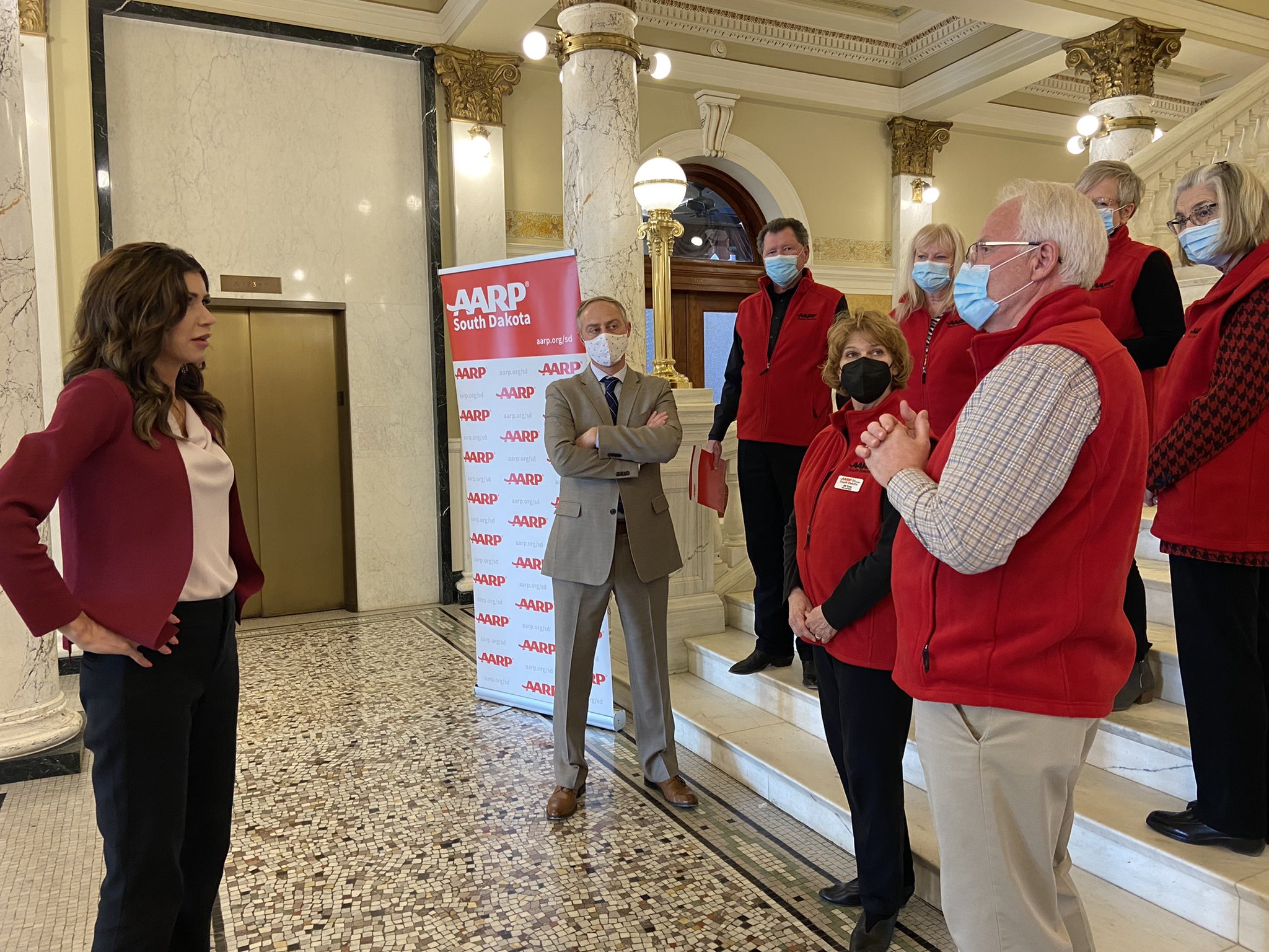 South Dakota Governor converses with AARP staff and volunteers.