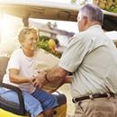 elderly couple bringing home groceries