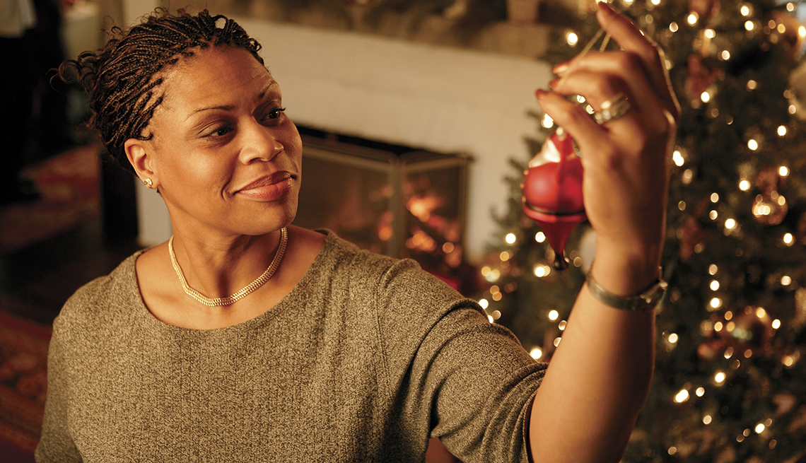 Woman hanging Christmas ornament