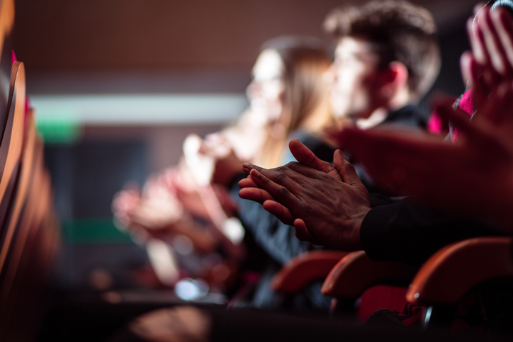 People in the theater, close up of clapping hands