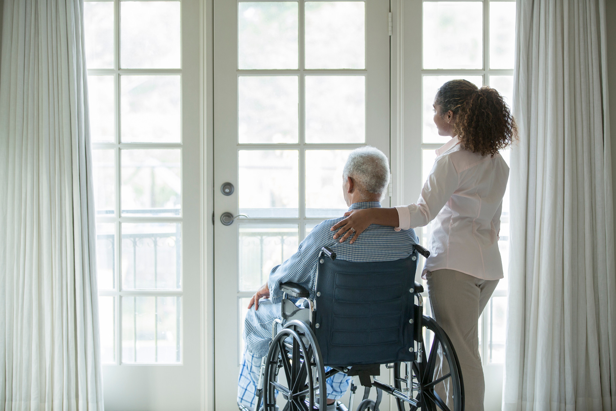 African American woman with Senior man in wheelchair