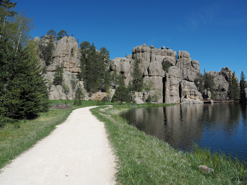 Path along a lake with rock formations in the South Dakota Black Hills