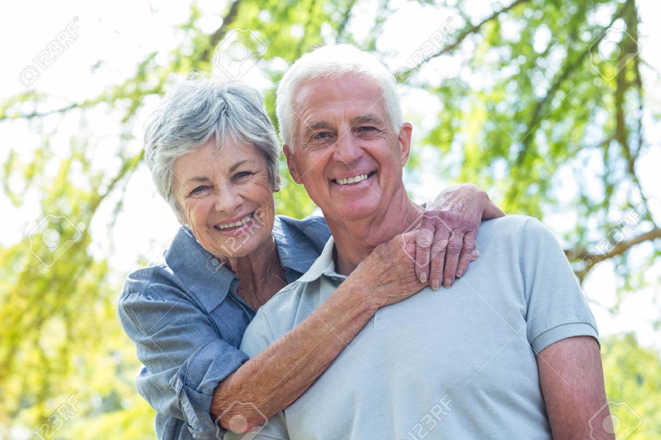 42670537-happy-old-couple-smiling-in-a-park-on-a-sunny-day.jpg