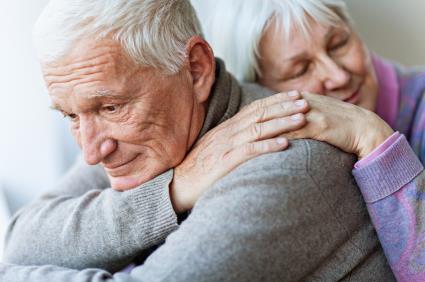 Caregivers holding onto one another in an embrace