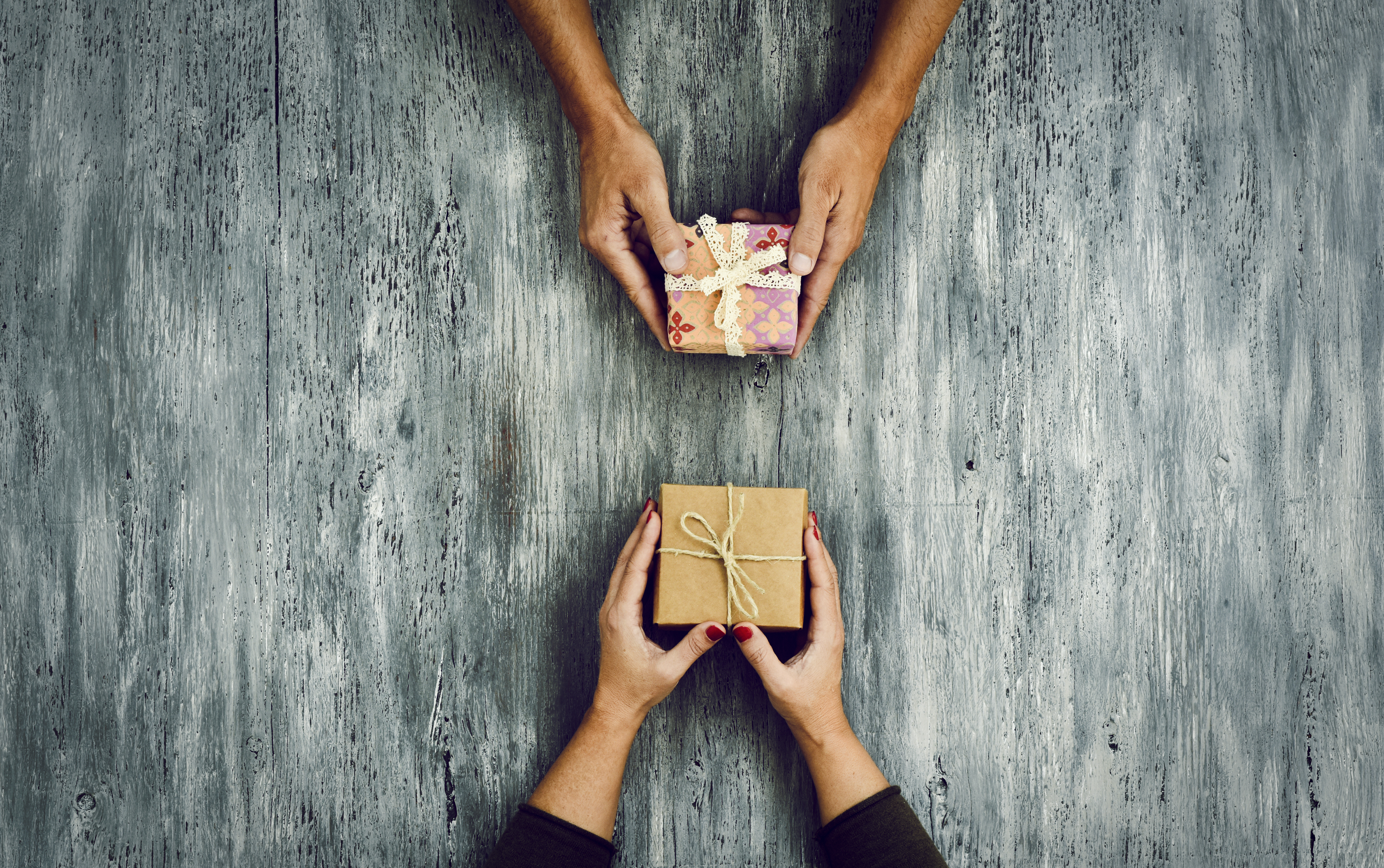 woman and man exchanging gifts