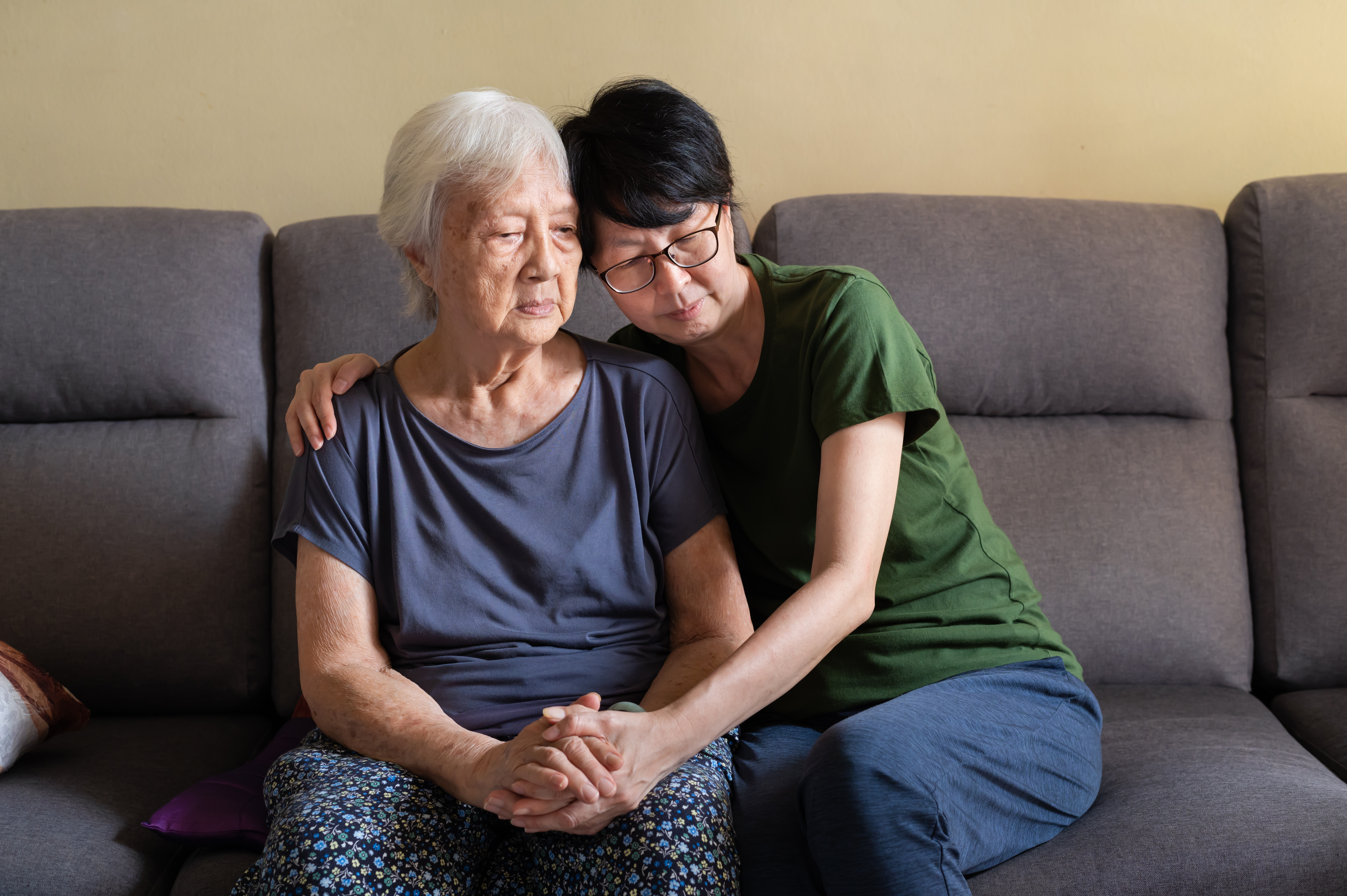 Asian daughter spending time with her elderly mother at home