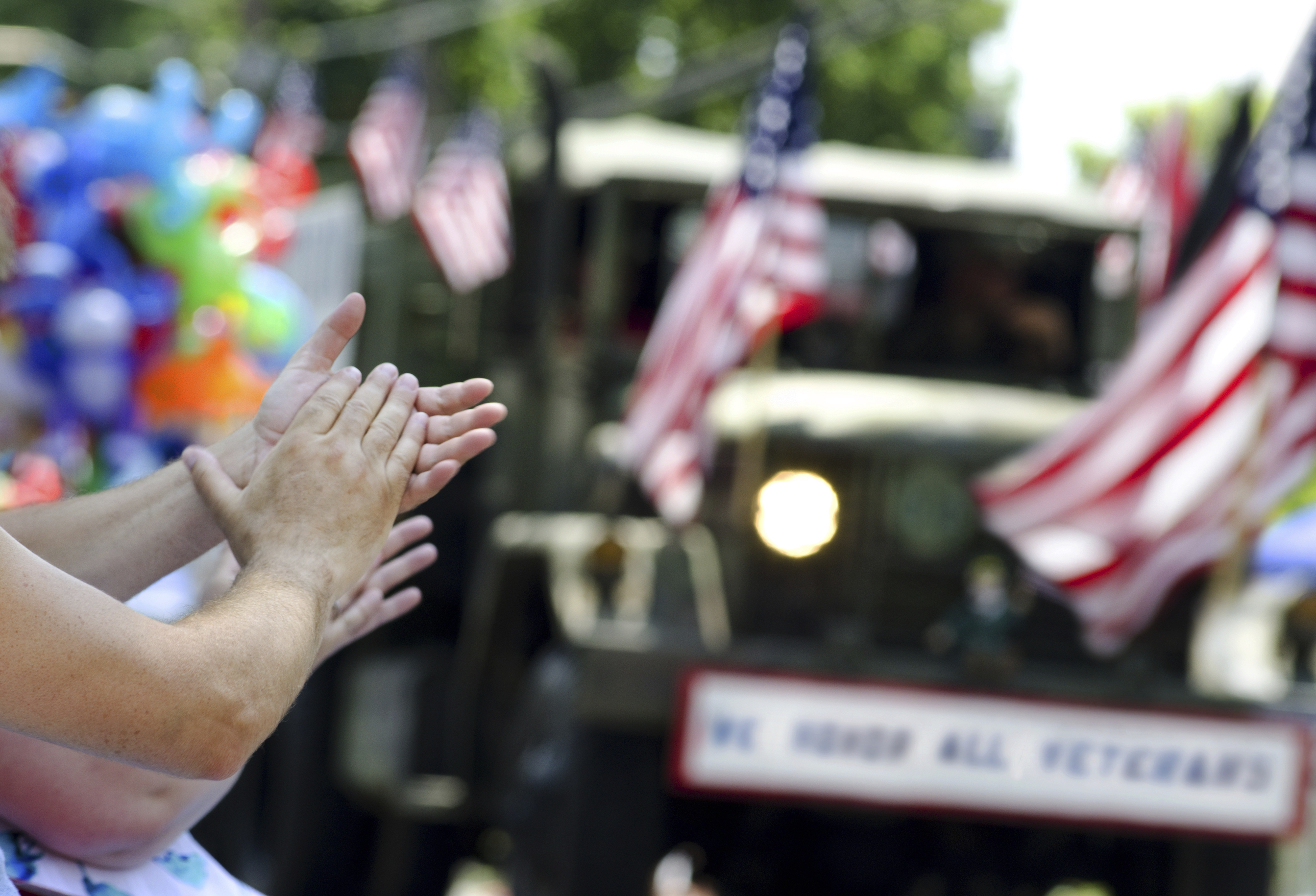 hands clapping at veterans parade