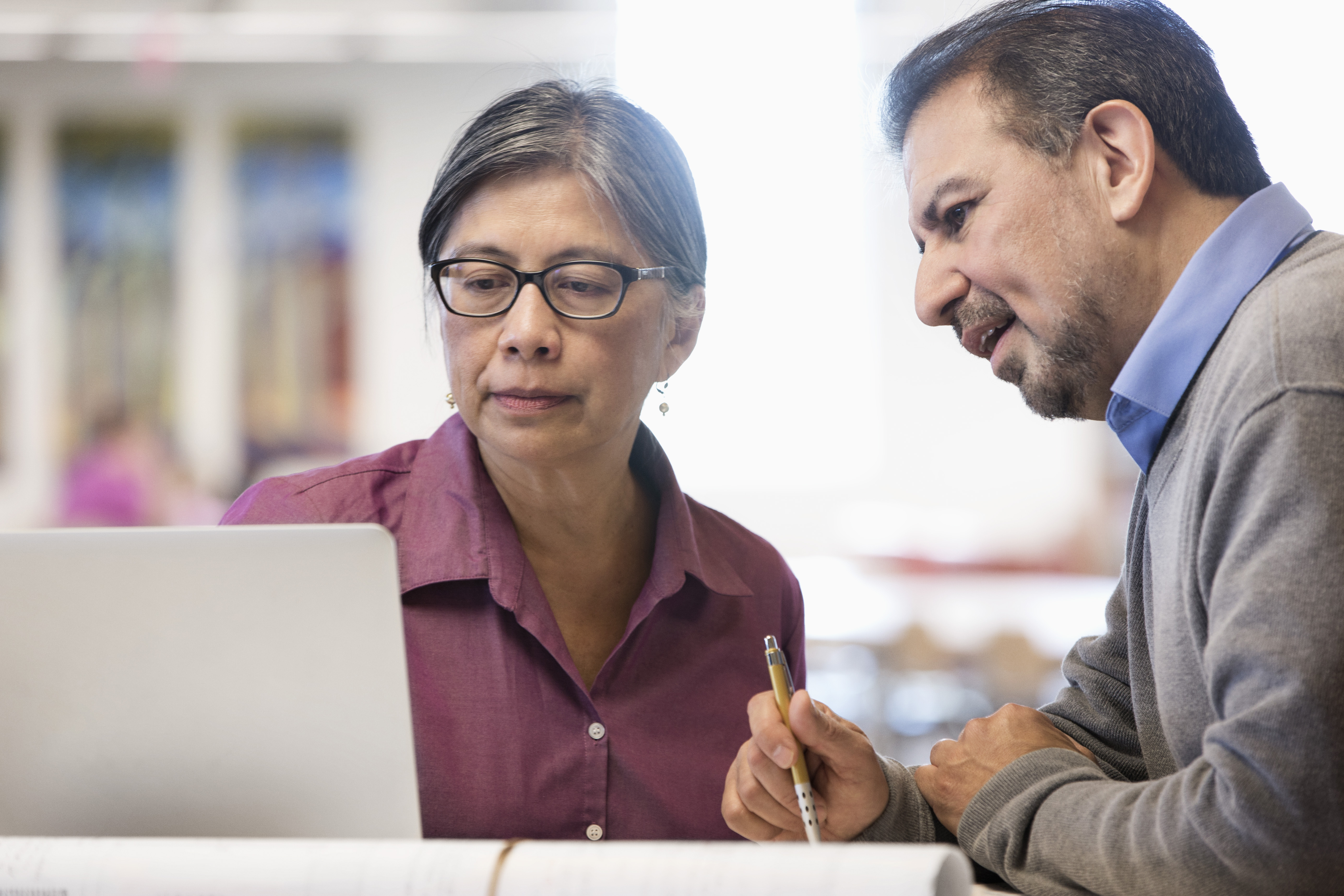 Business people using computer in library